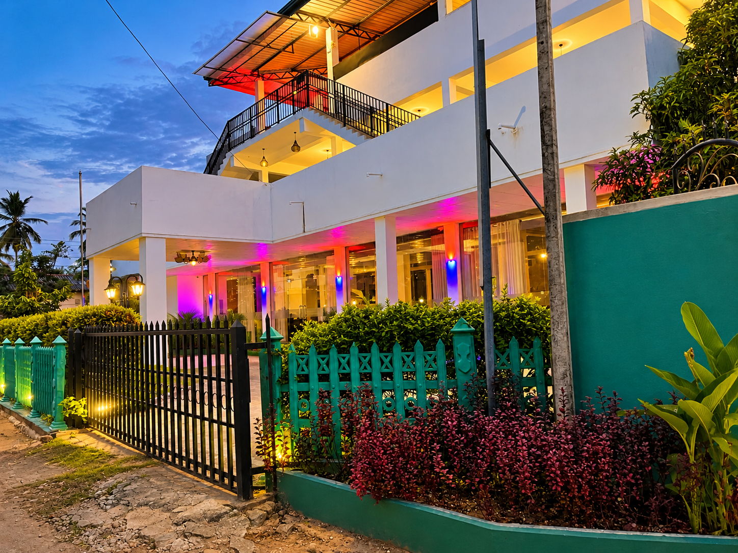 Official evening exterior view of Hotel Green View Buttala showing the illuminated multi-story building, entrance and rooftop